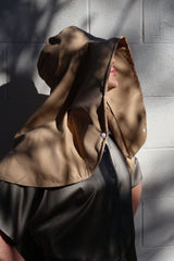 Woman wearing a beige Sun Safe hat that covers face and shoulders