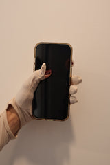 SunSafe UV blocking sleeve with fingers revealed holding smart phone